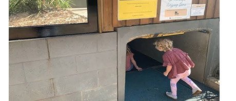 A young visitor entering the finished access tunnel to the crocodile viewing dome
