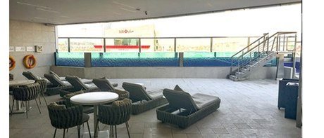 Poolside lounge beside the acrylic-walled pool