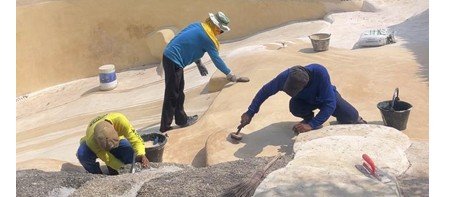 Reefscape Rock being applied to a pool by hand